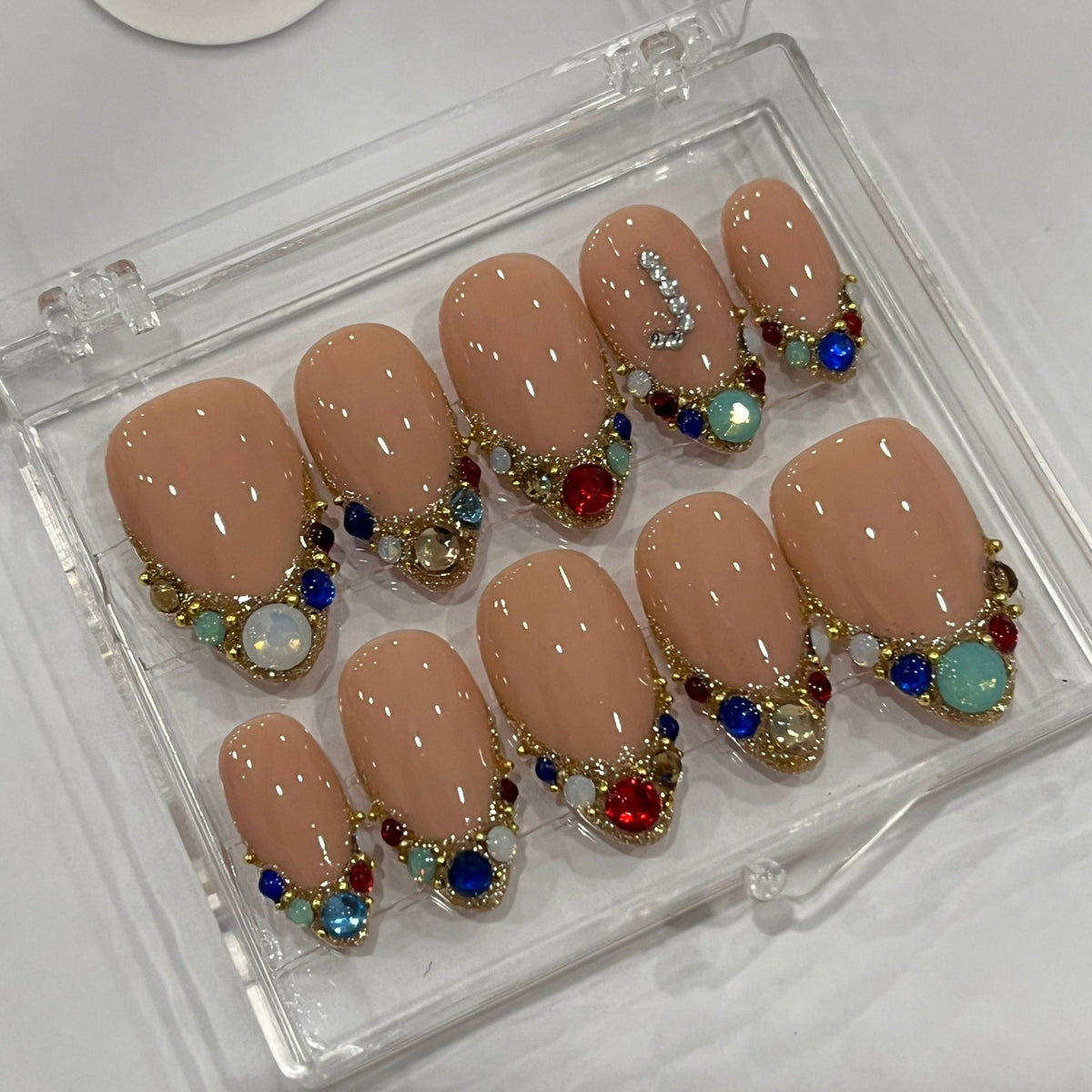 Nude Beige Initial Press-On Nails With Gold Beading and Multicolored Rhinestones