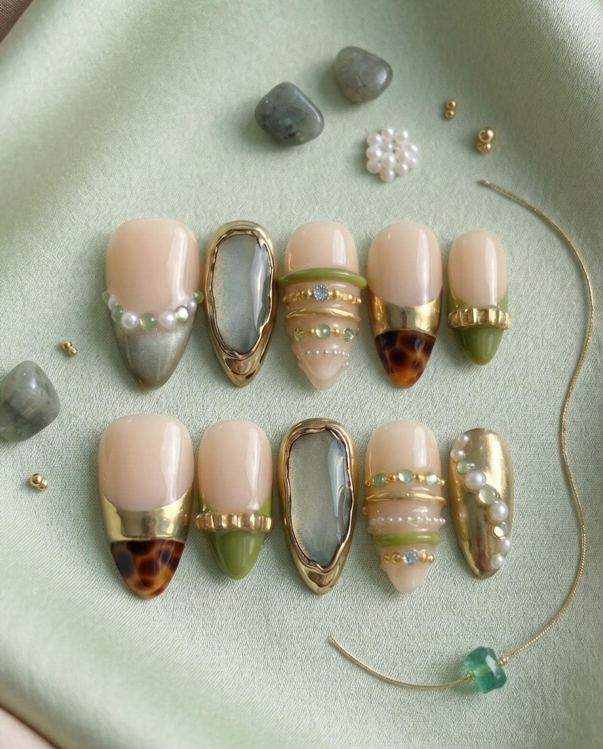 Nude Beige Press-On Nails With Gold Chrome Bangles, Tortoiseshell Tips and Green Gem Details