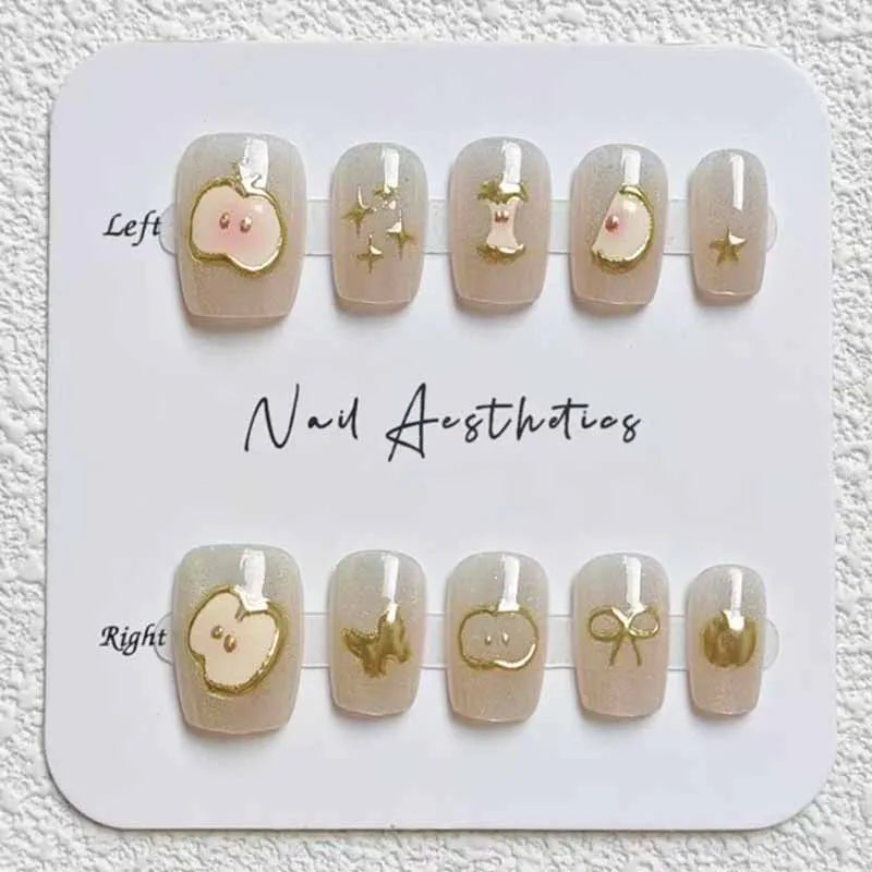 Nude Cat Eye Nails With Golden Apple Charms and Star Accents