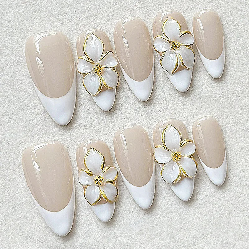 Nude French Tip Nail Set with Raised White Flowers and Gold Accents