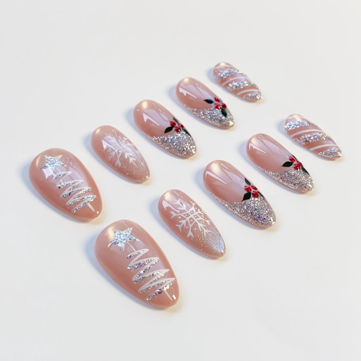 Nude Pink Christmas Nails With Silver Glitter Trees, Snowflakes, and Holly