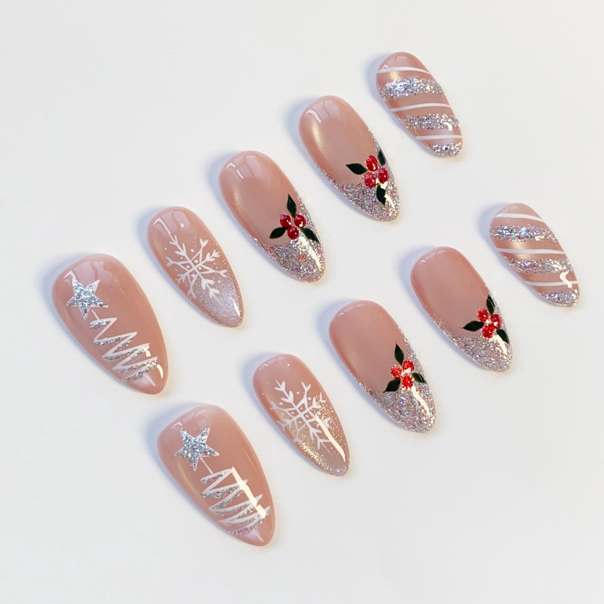 Nude Pink Christmas Nails With Silver Glitter Trees, Snowflakes, and Holly