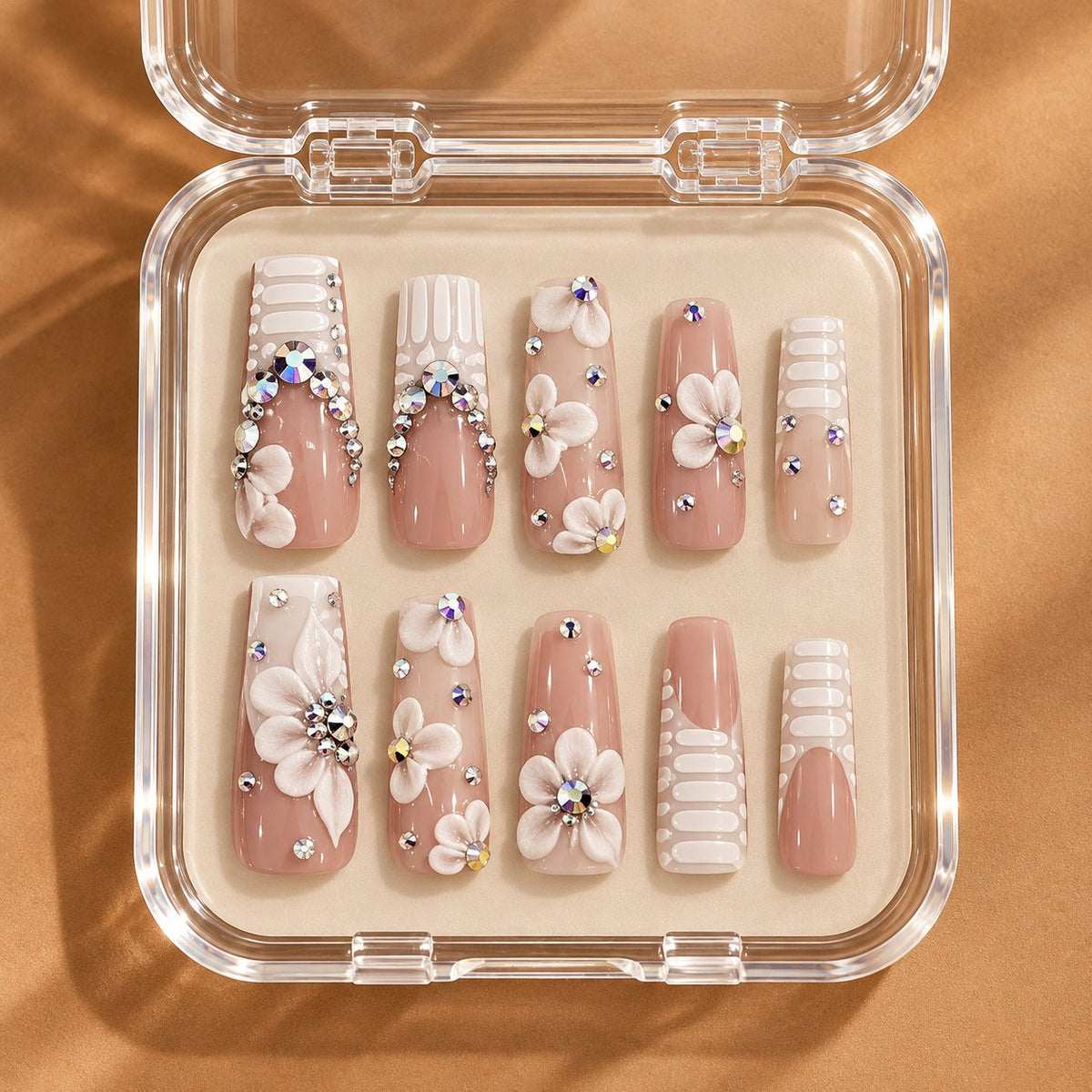 Nude Pink French Tip Nails With 3D White Flowers and Rhinestones in clear acrylic storage box