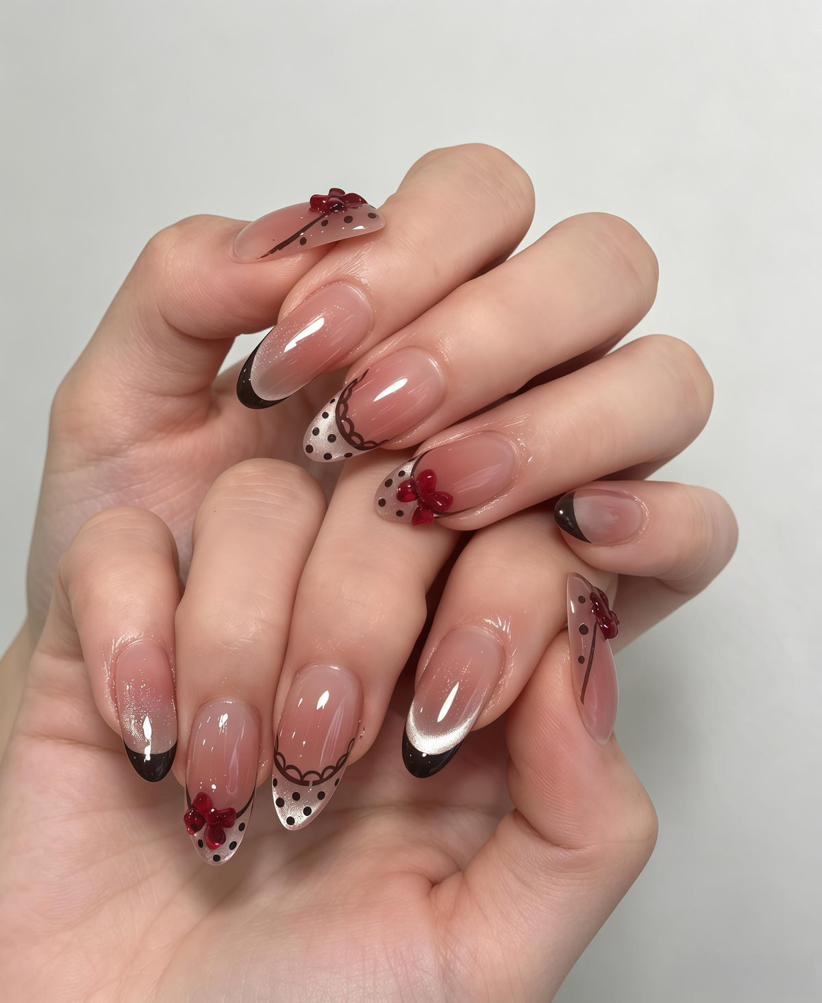 Nude Pink French Tip Nails With Black Polka Dots and 3D Red Bows