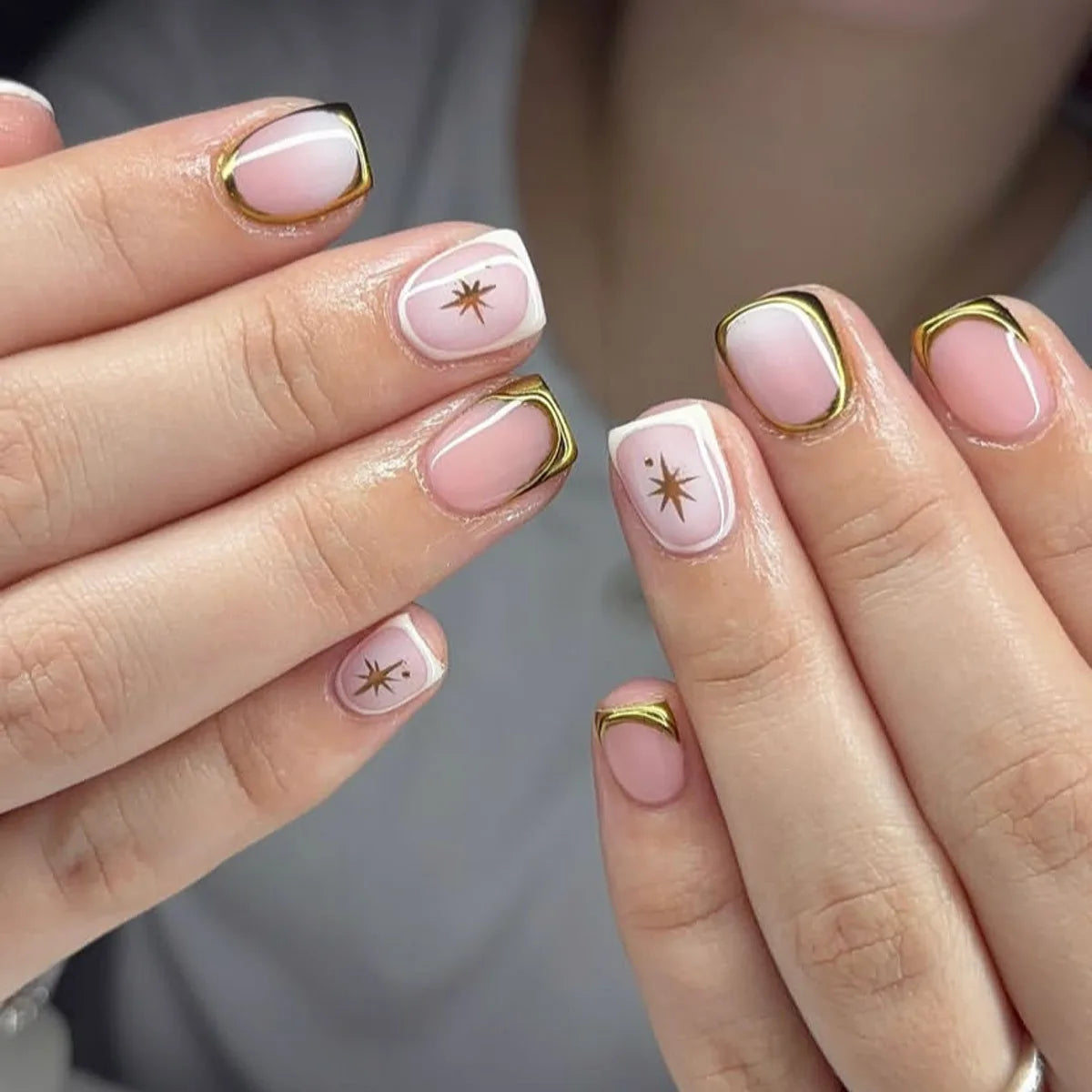 Nude Pink French Tip Nails With Metallic Gold Edging and Starbursts