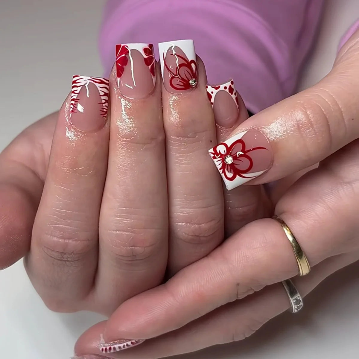 Nude Pink French Tip Nails with Red Floral Line Art and Rhinestones