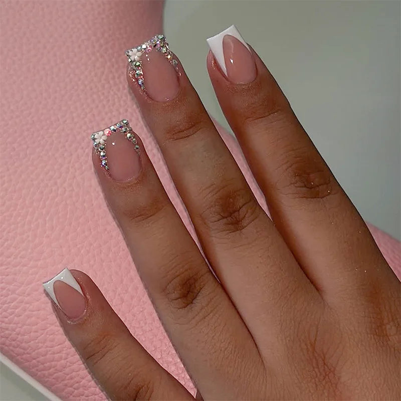 Nude Pink French Tip Nails With Rhinestone Borders And Flower Accents