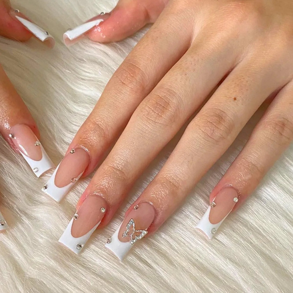 Nude Pink French Tip Nails With Silver Butterfly Charm and Rhinestones