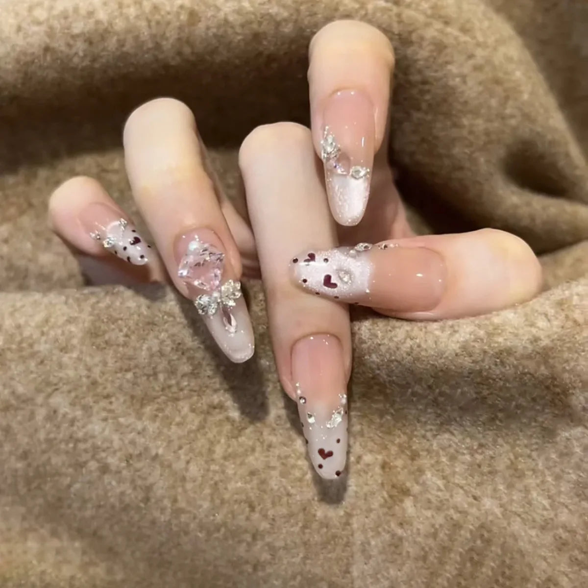 Nude Pink French Tip Nails with Silver Glitter, Hearts, Rhinestones and Bow Accent
