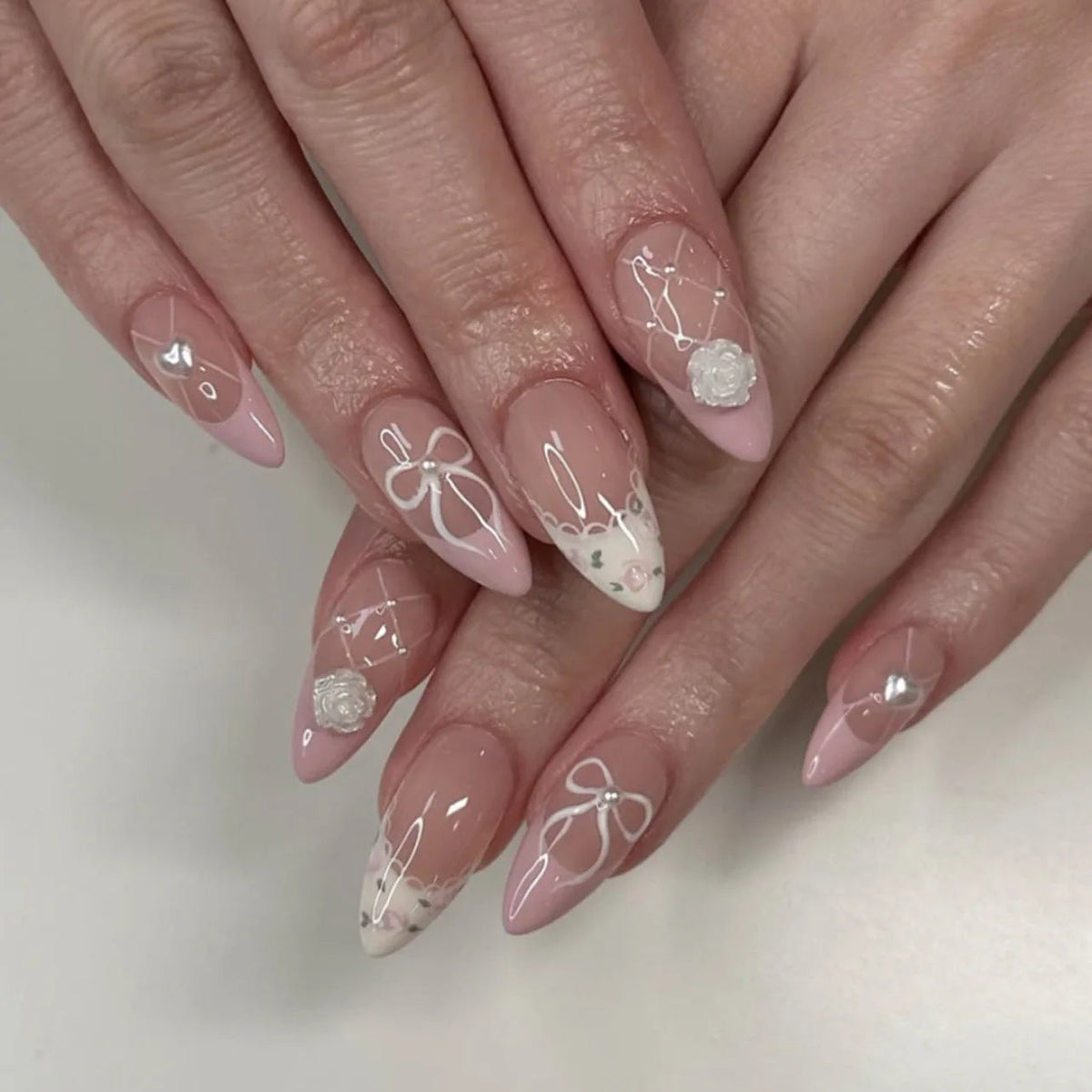 Nude Pink French Tip Nails with White Bows and Floral Accents