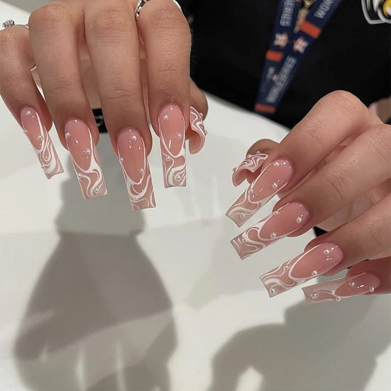 Nude Pink French Tip Press-On Nails With White Swirls and Rhinestones