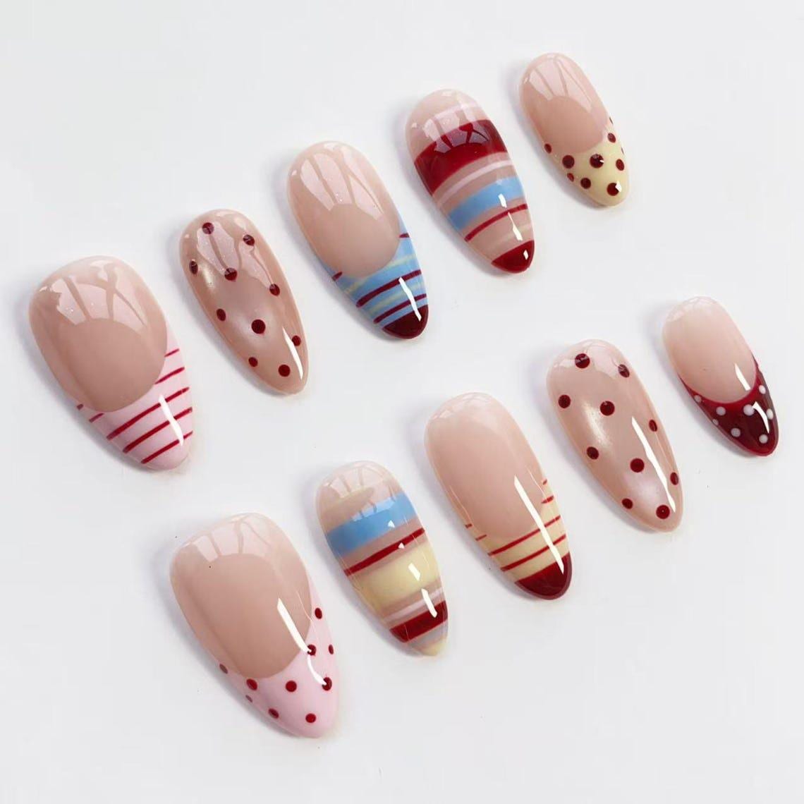 Nude Pink Nails with Burgundy Polka Dots and Colorful Stripes