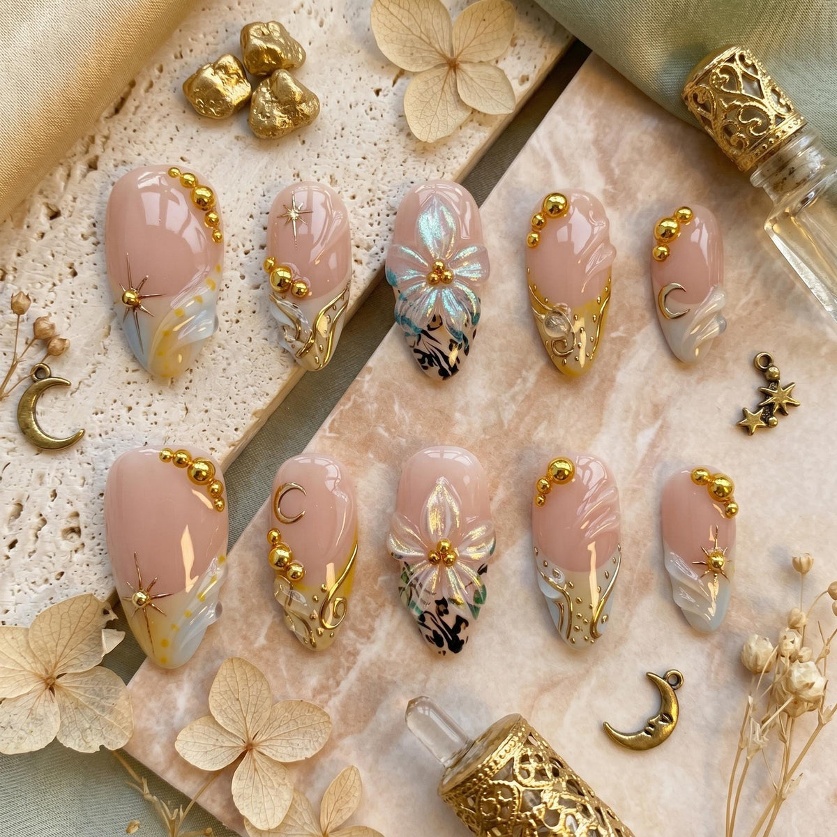 Nude Pink Shell-Inspired Nails with Blue Floral Art and Gold Details