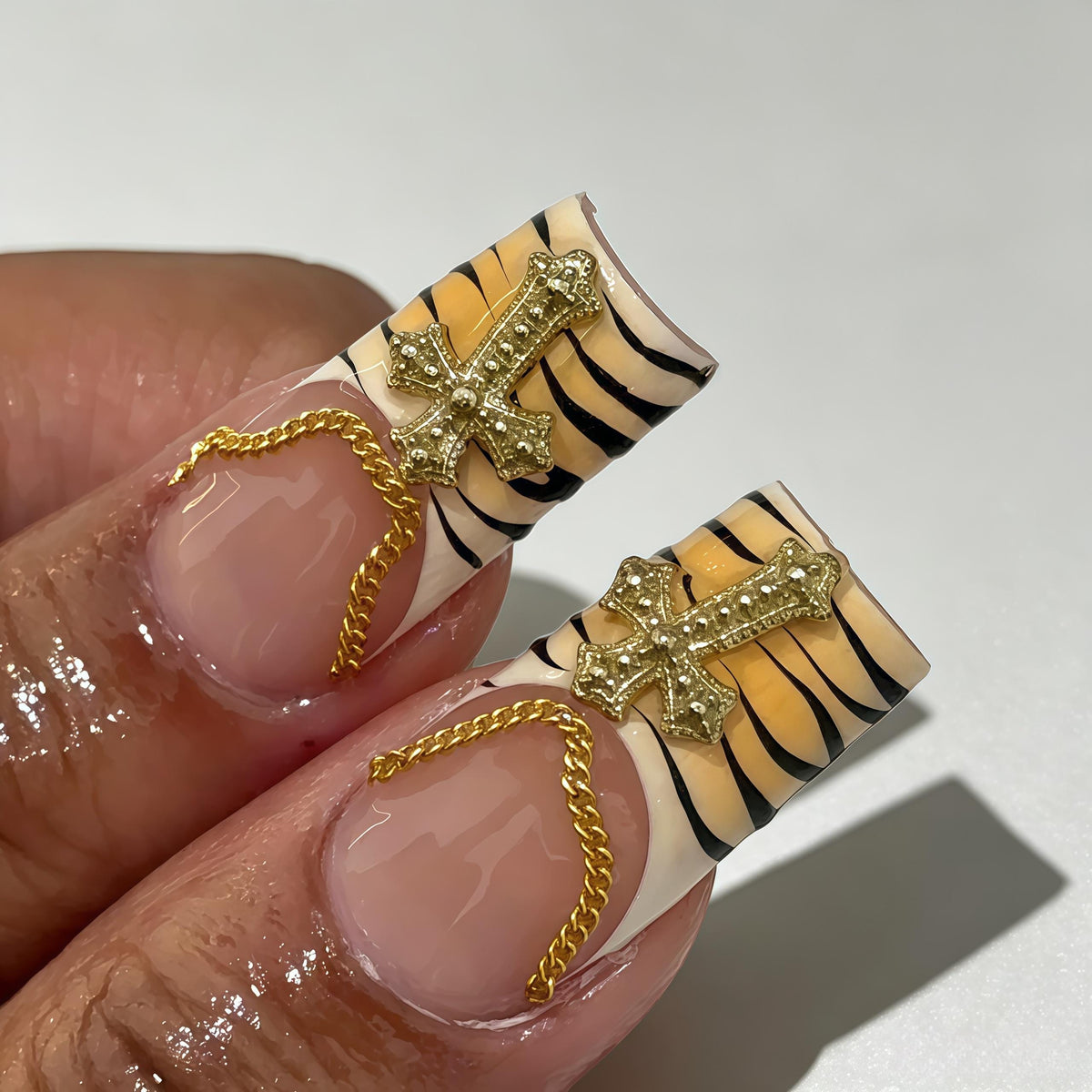 Opera-Inspired Pink Swirl Nails with Stripes and Jeweled Gold Charms