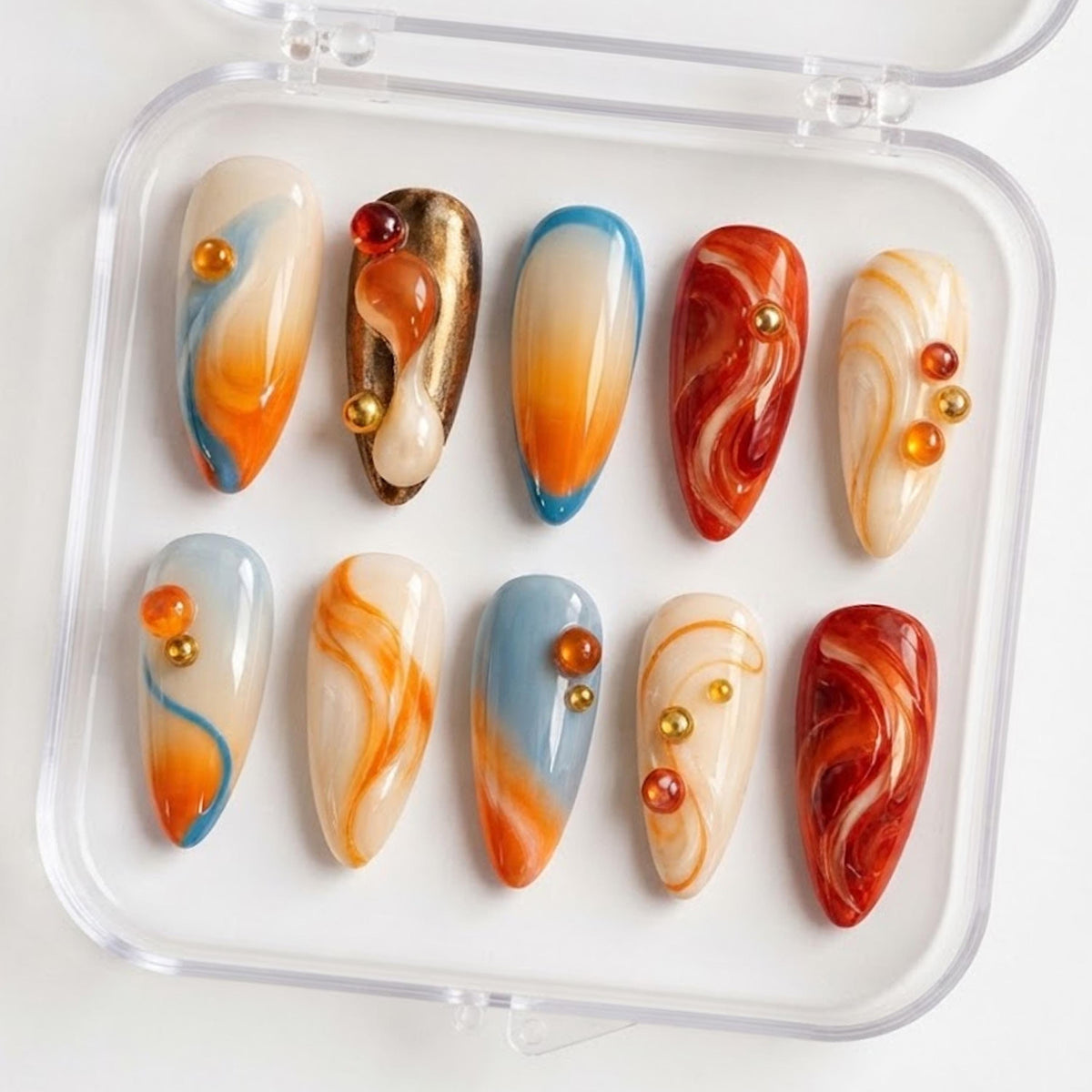Orange and Icy Blue Jelly Nails with Amber Swirls and 3D Bead Accents