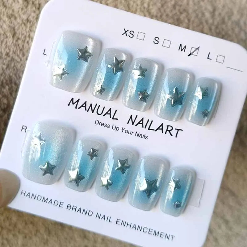 Pale Blue Cat-Eye Nails with Silver Star Accents