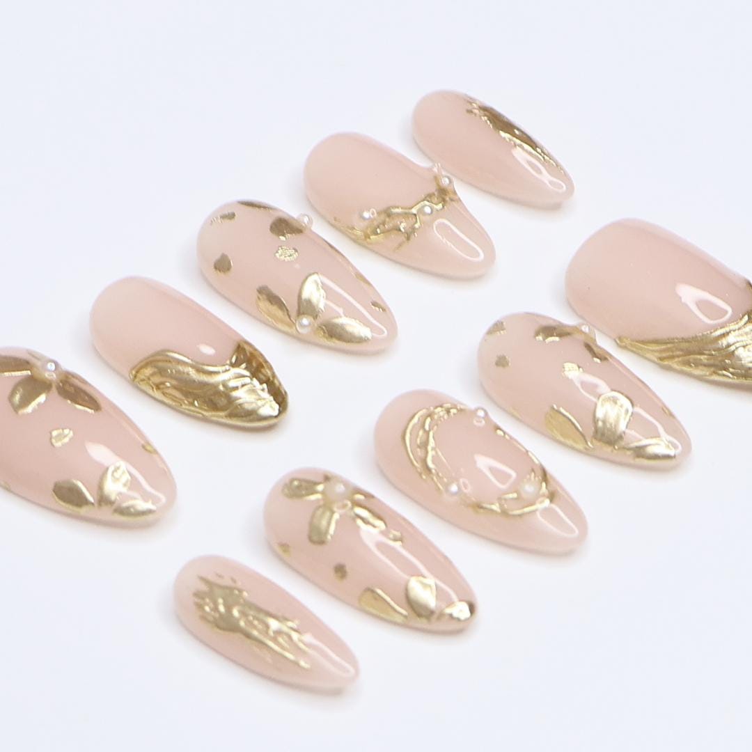 Pale Nude Pink Nails with Sculpted Gold Floral Details and Pearl Accents