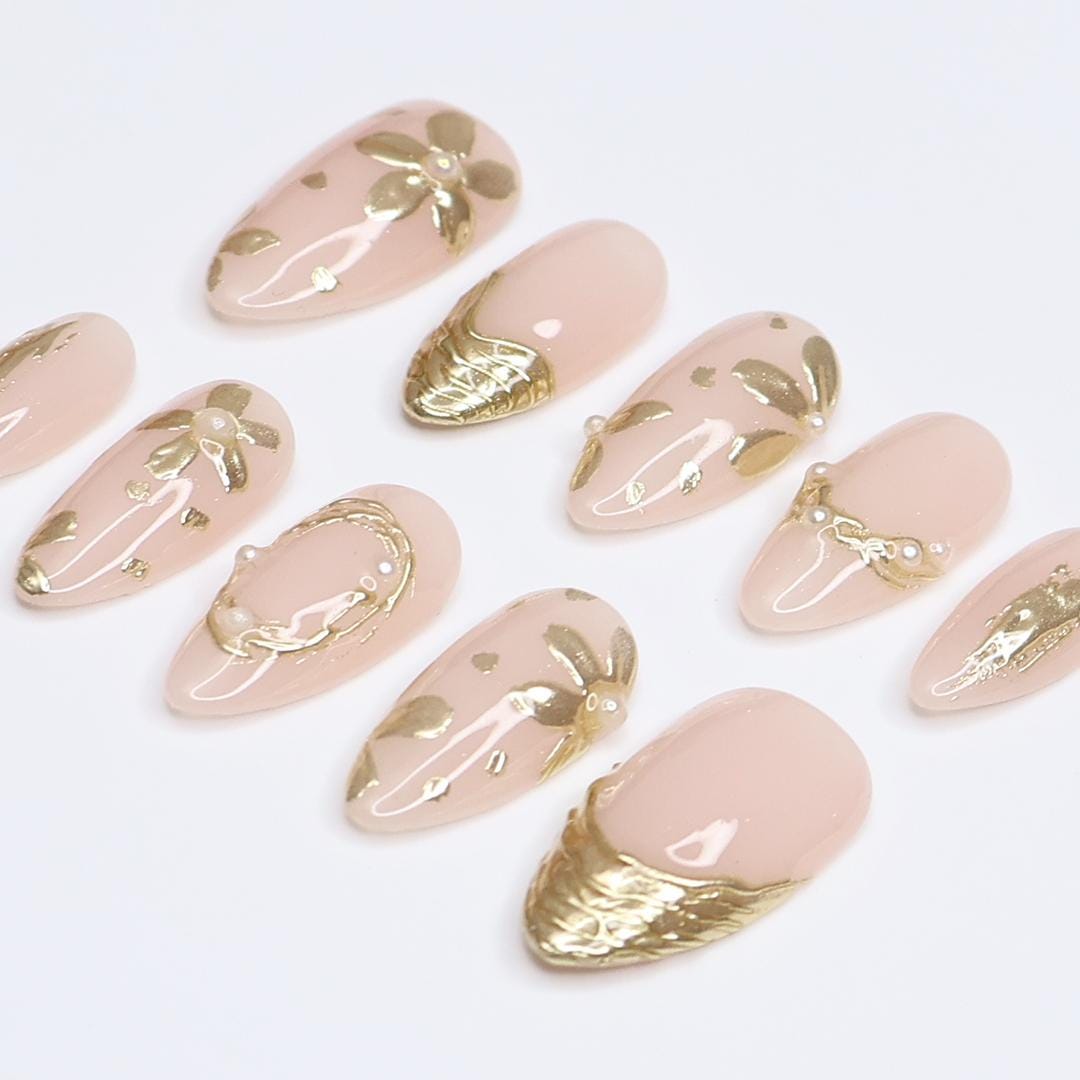 Pale Nude Pink Nails with Sculpted Gold Floral Details and Pearl Accents
