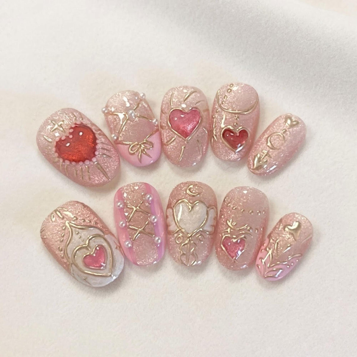 Pale Pink Glitter Heart Nails With Gold Scrollwork and Raised Accents