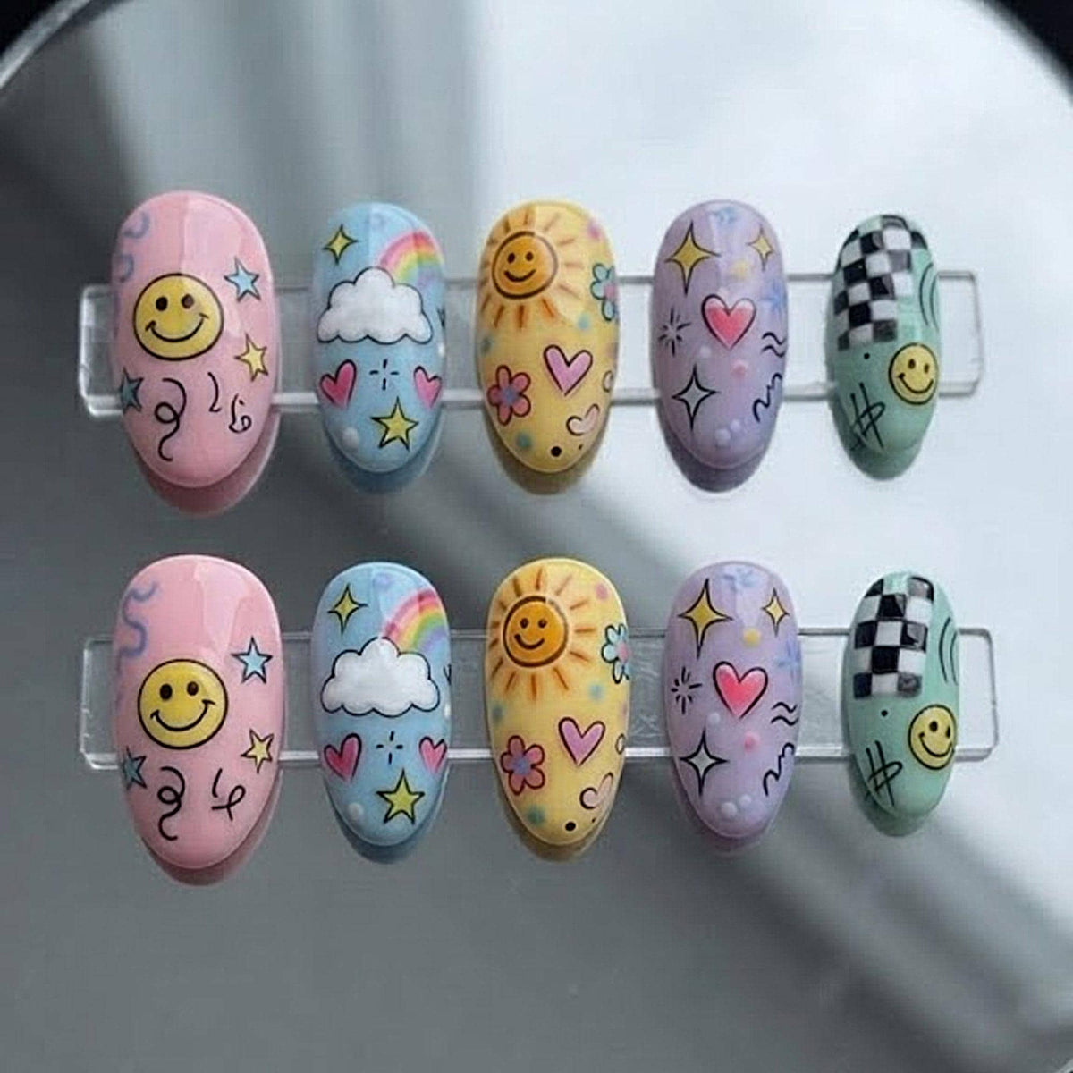 Pastel Retro Smiley Face Press-On Nails With Rainbows, Clouds and Checkerboard Accents