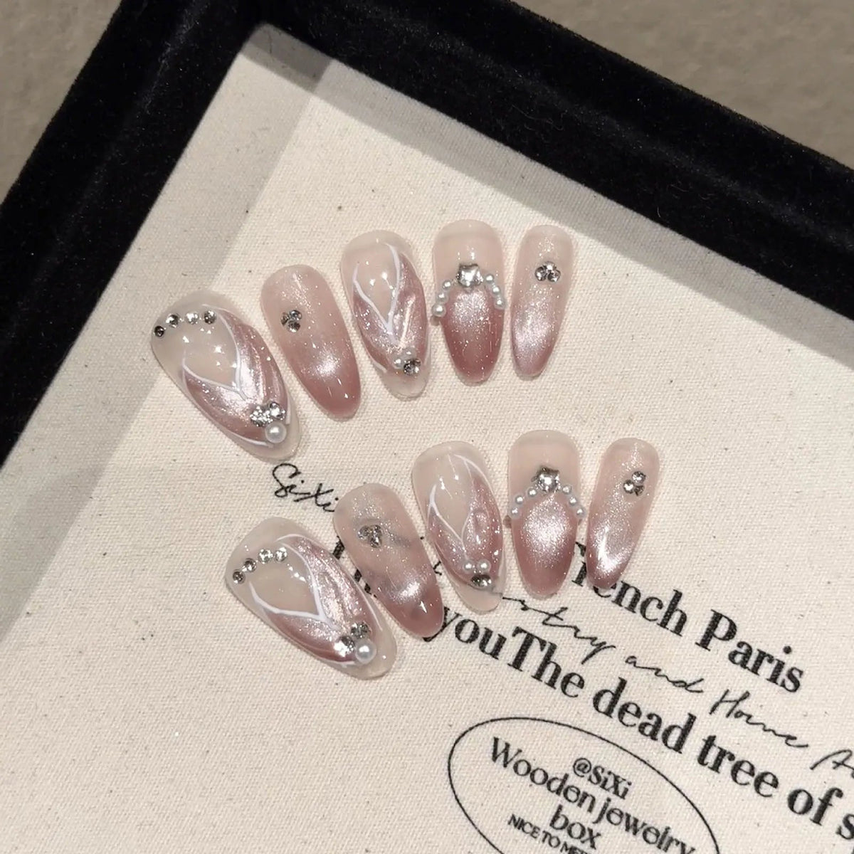 Pearly Nude Pink French Tip Nails with White Linework and Silver Rhinestones