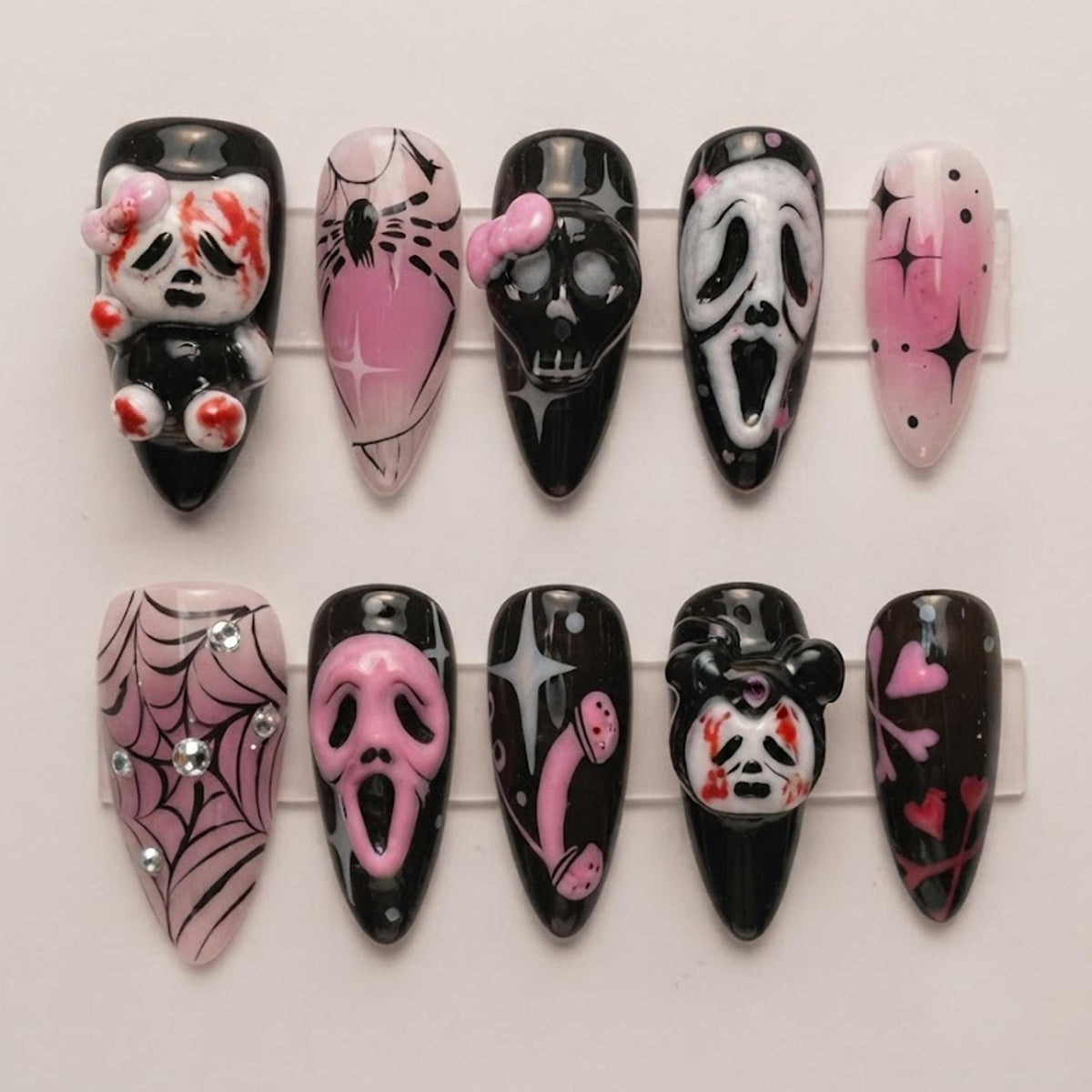 Pink and Black Gothic Halloween Nails With Horror Masks, Skulls, Spiderwebs, and Bows