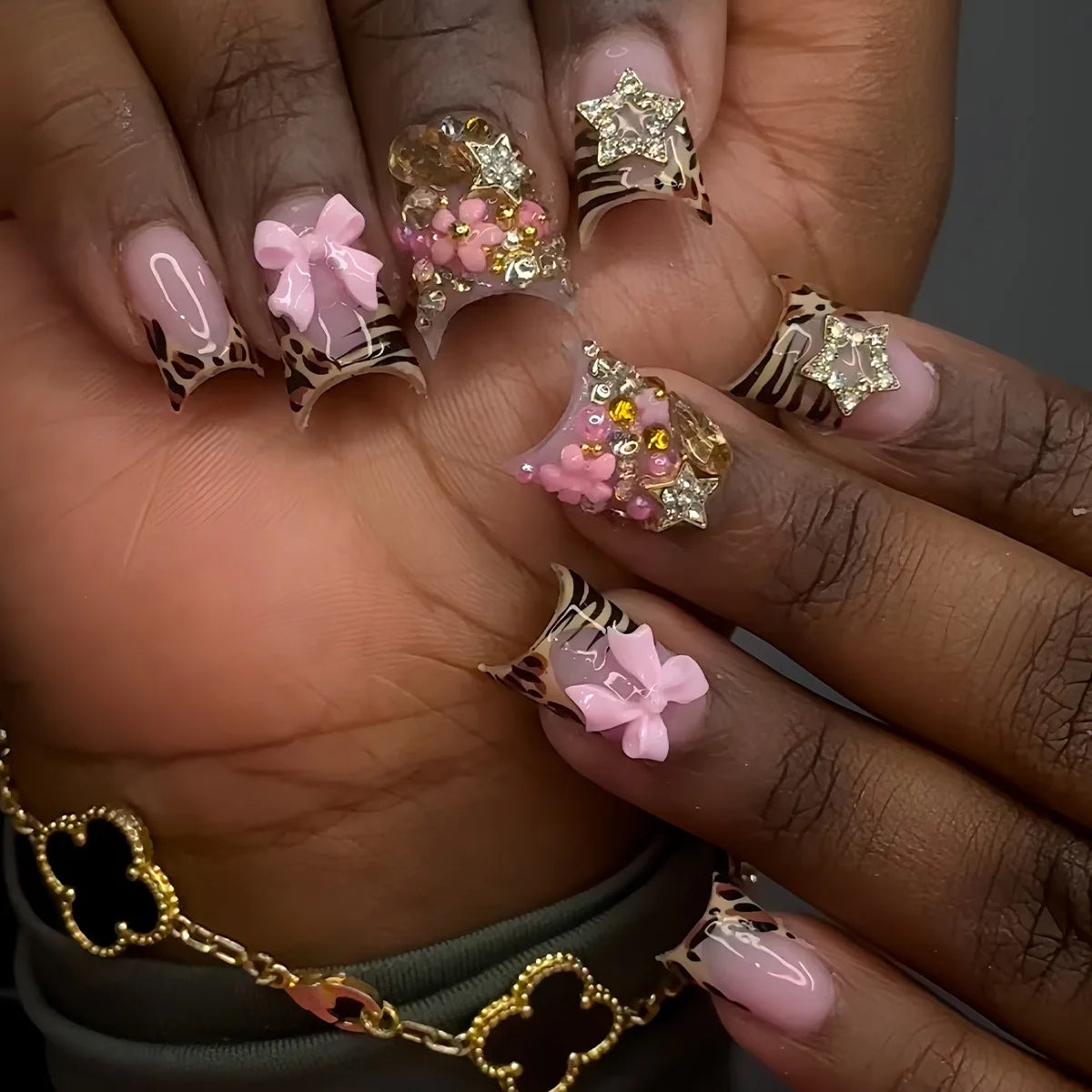 Pink Animal-Print French Tip Nails with 3D Bows and Gold Star Charms