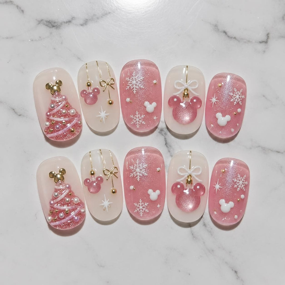 Pink Christmas Nails With Snowflakes, Bows, and Raised Tree Details