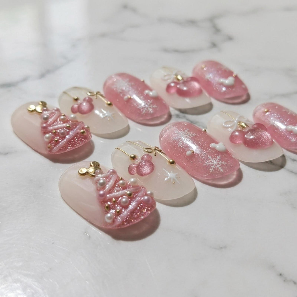 Pink Christmas Nails With Snowflakes, Bows, and Raised Tree Details