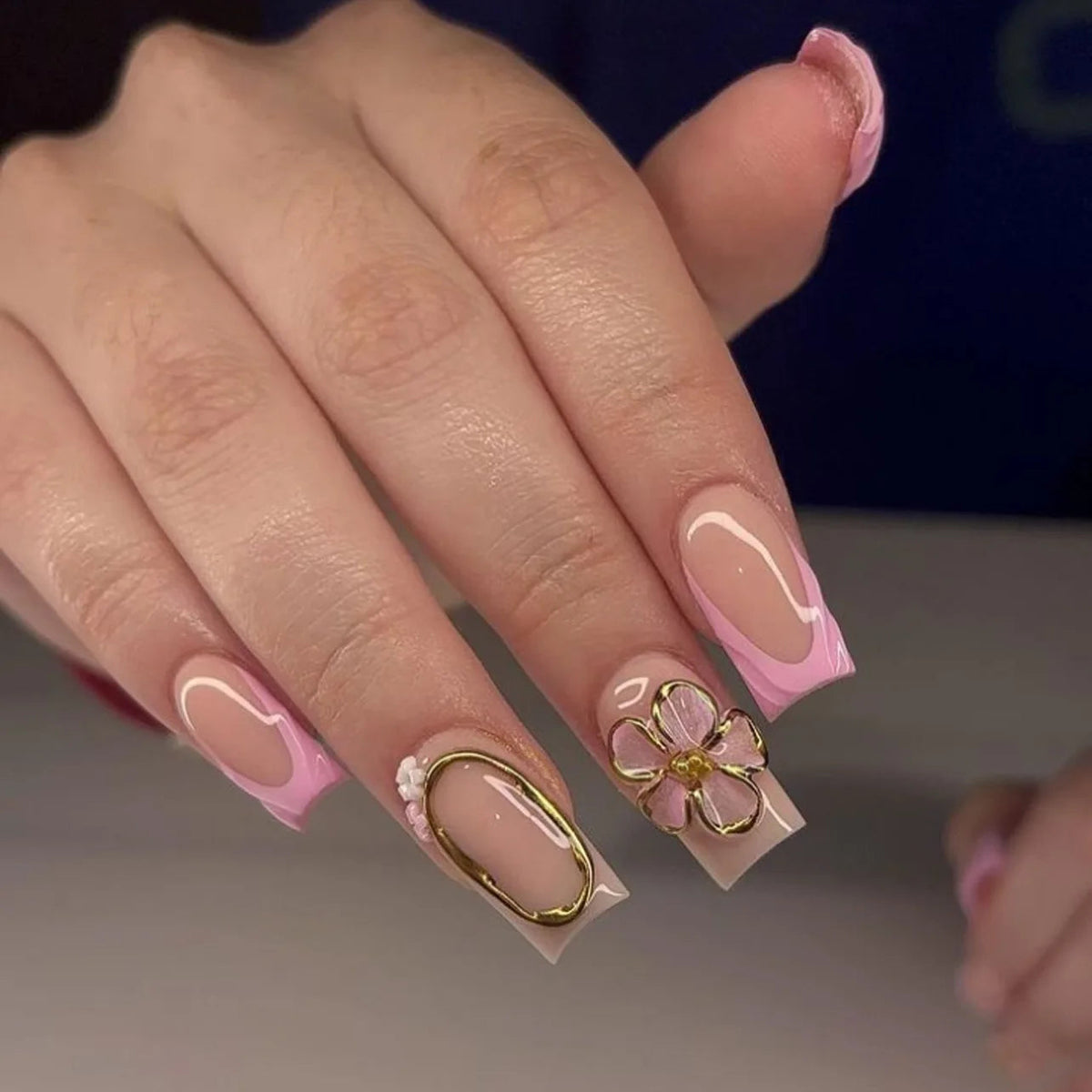 Pink French Tip Nails with Gold Flower Charm and Curved White Lines