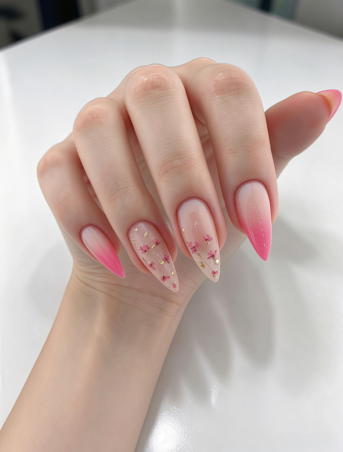 Pink Gradient Nail Set With Floral Accents and Gold Foil