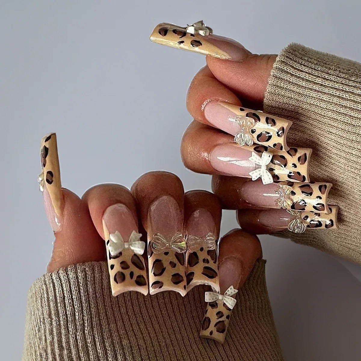 Pink Leopard Print Nails With White 3D Bows and Metallic Dangling Charms