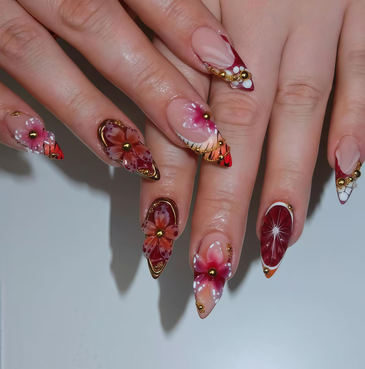 Pink Tropical Flower Press-On Nails With Red Tips and Gold Chain Details
