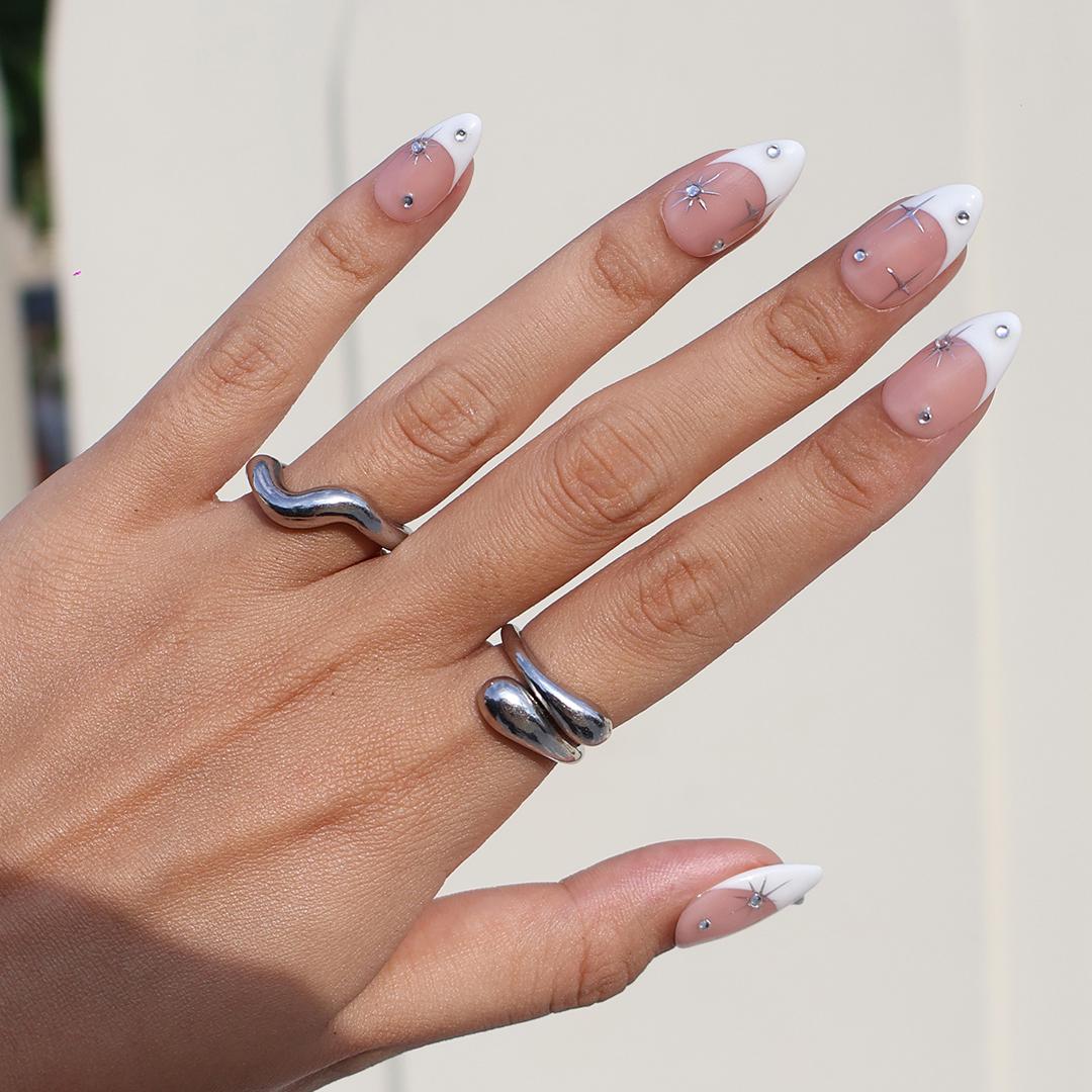 Blush Pink French Tip Nails with Silver Stars and Rhinestone Accents