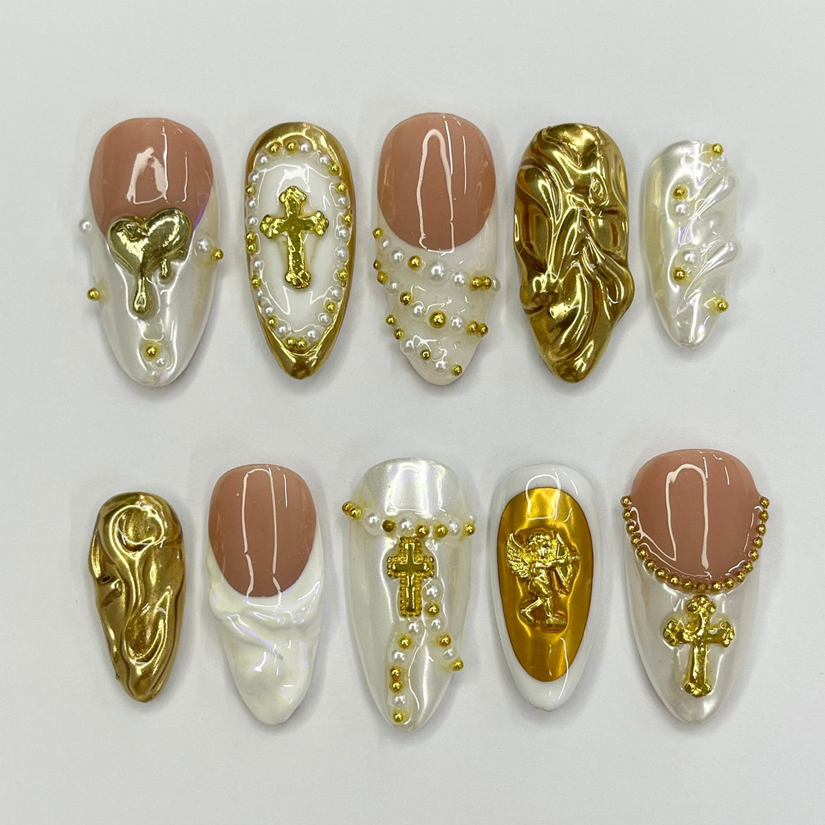 Cupid-Inspired Nude and Ivory French Tip Nails with Gold Crosses and Baroque Accents