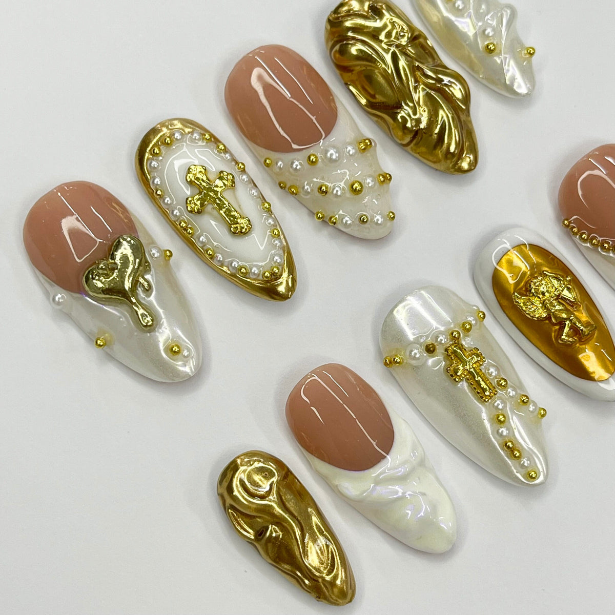 Cupid-Inspired Nude and Ivory French Tip Nails with Gold Crosses and Baroque Accents