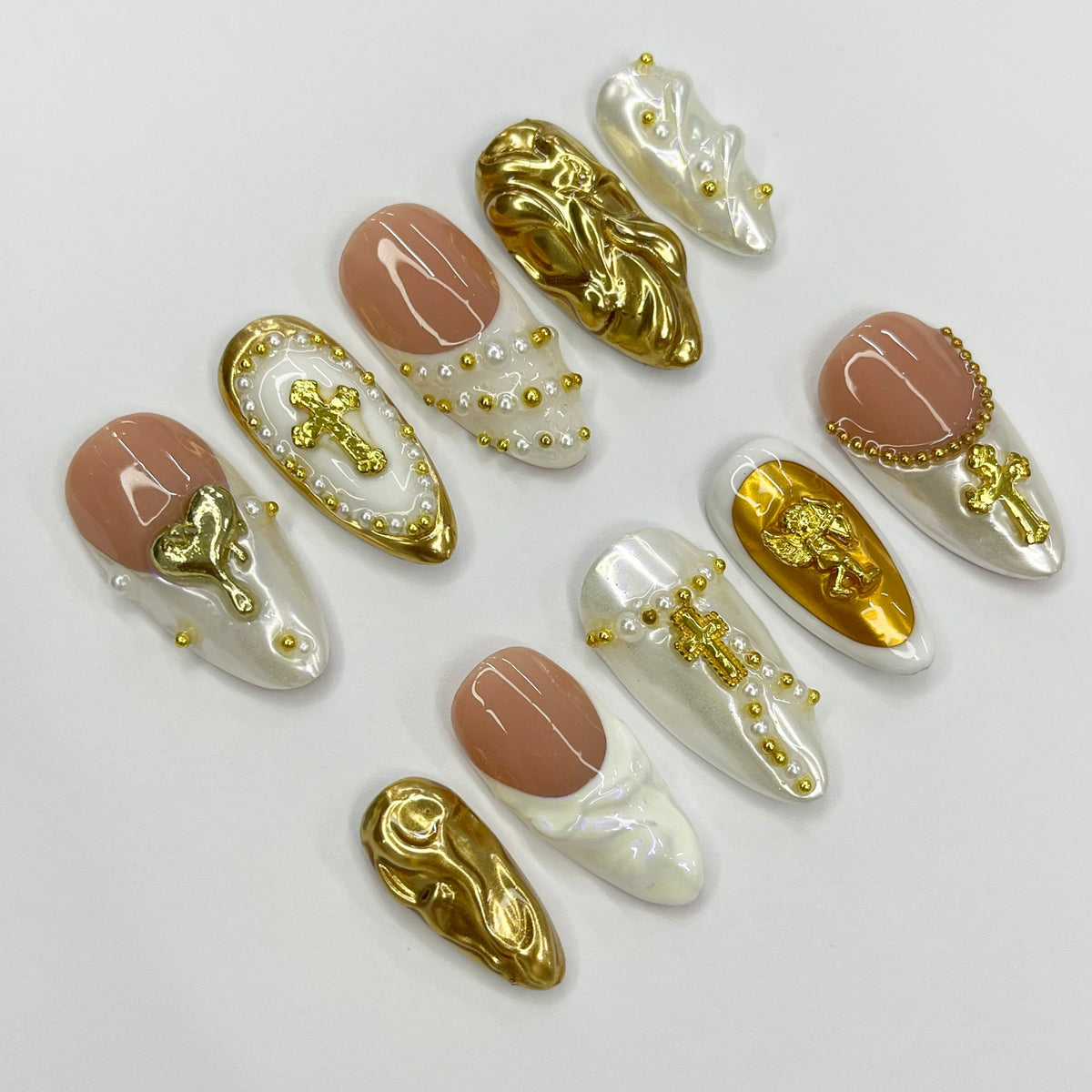 Cupid-Inspired Nude and Ivory French Tip Nails with Gold Crosses and Baroque Accents