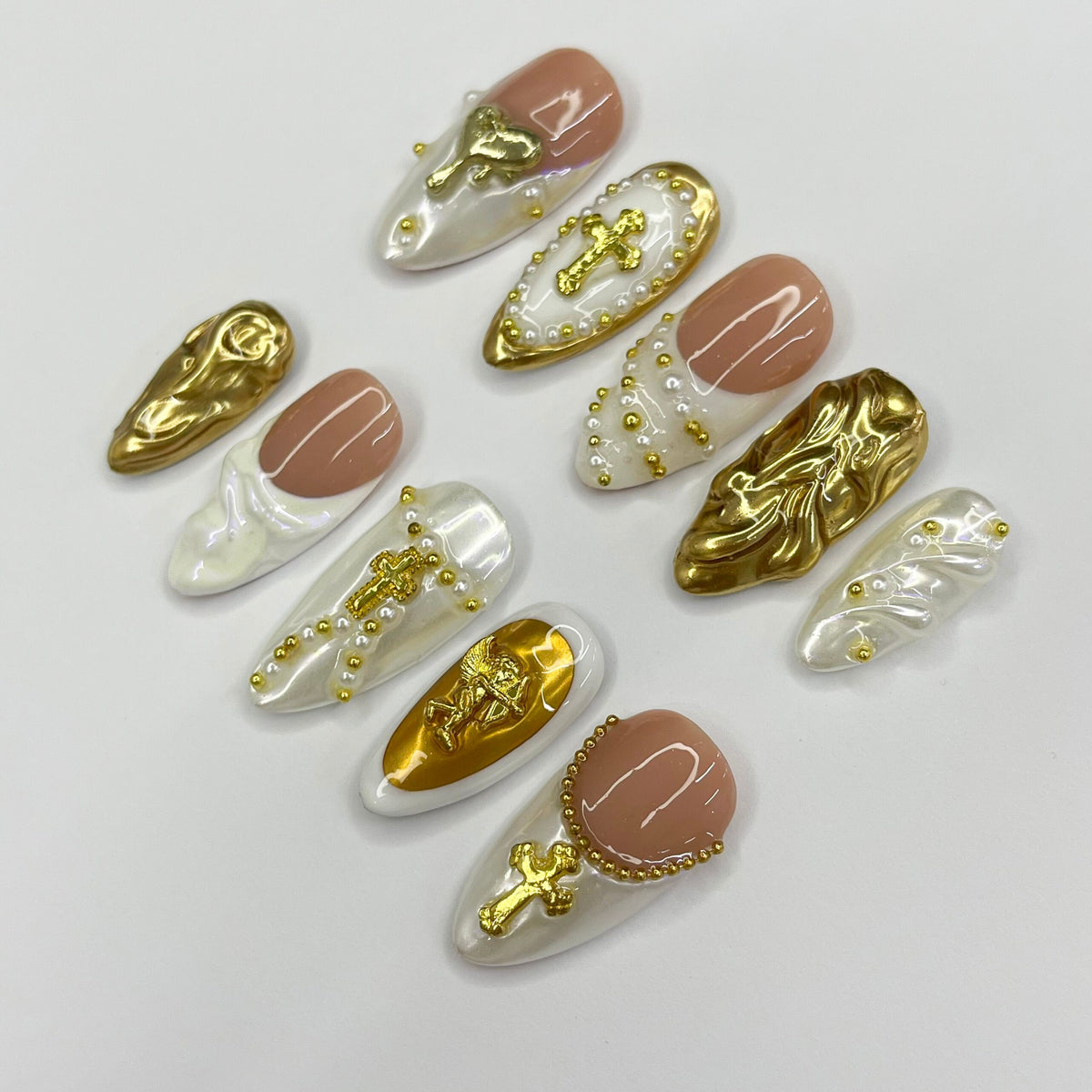 Cupid-Inspired Nude and Ivory French Tip Nails with Gold Crosses and Baroque Accents