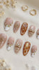 Brown Cat Eye and Blush French Tip Nails with Gold Sun Details