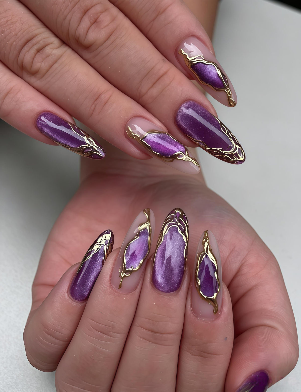 Purple Cat Eye Nails with Lavender Streaks and Irregular Gold Foil Borders