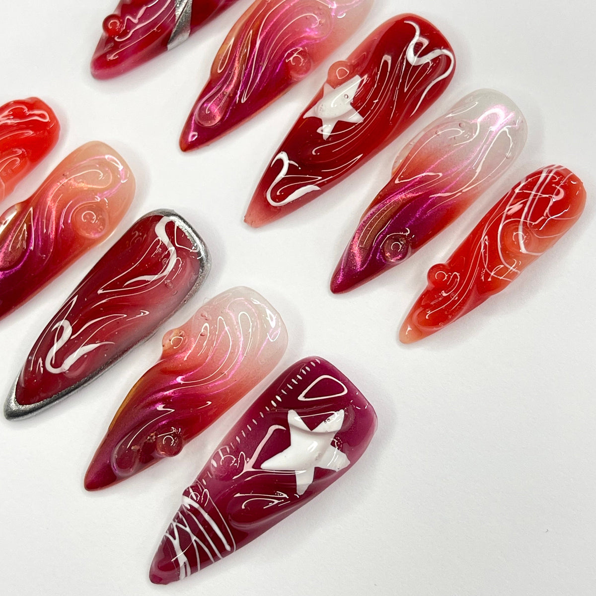 Red and Burgundy Swirl Press On Nails With White Star Charms and Silver Accents