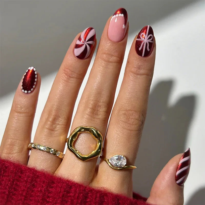 Red and Pink Christmas Candy Swirl Nails with Bows and Polka Dot Details