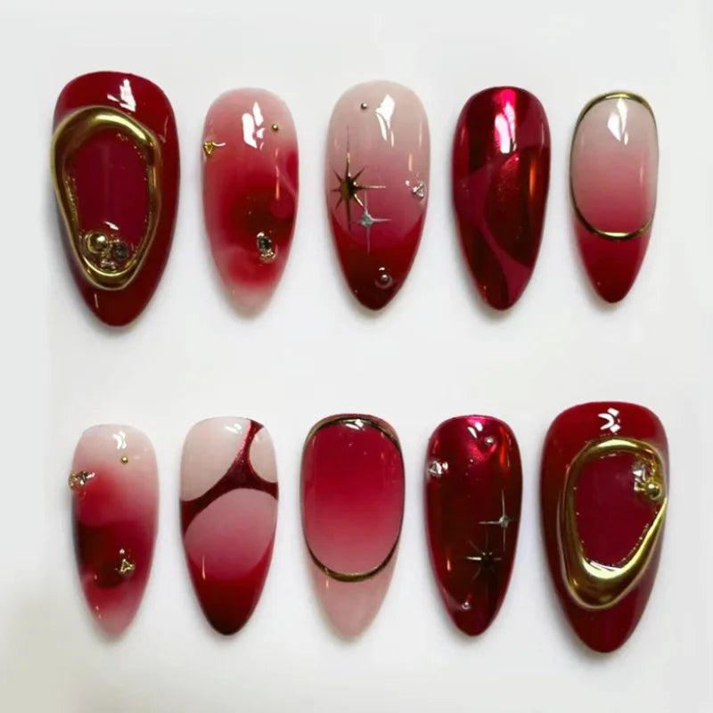 Red and Pink Ombre Nails with Gold Frames, Star Motifs and Rhinestone Accents