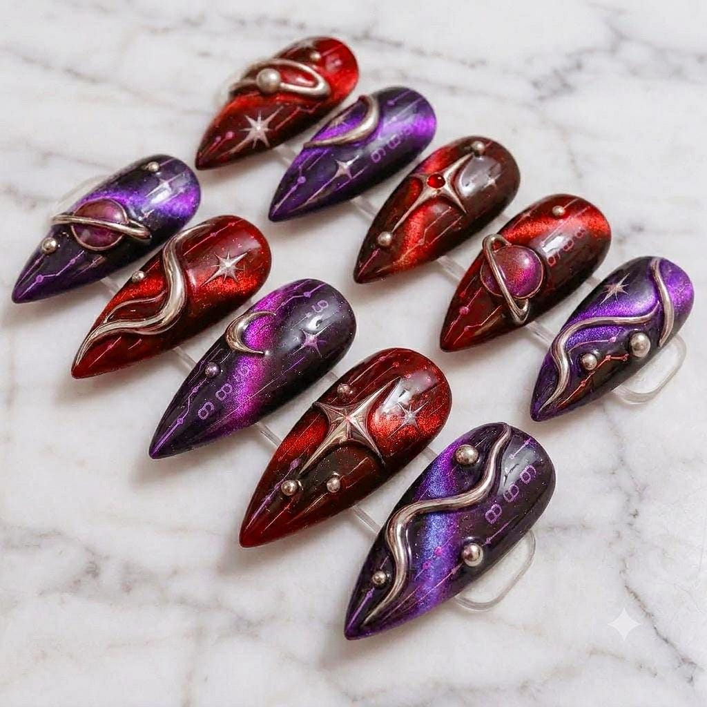 Red and Purple Galaxy Cat-Eye Nails with Silver Planet Rings and Stars