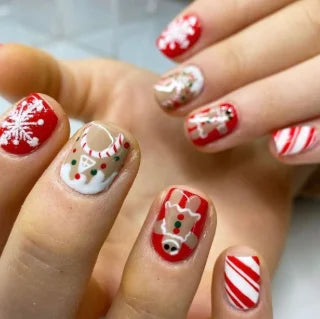 Red and White Christmas Nails With Snowflakes, Candy Cane Stripes, and Reindeer