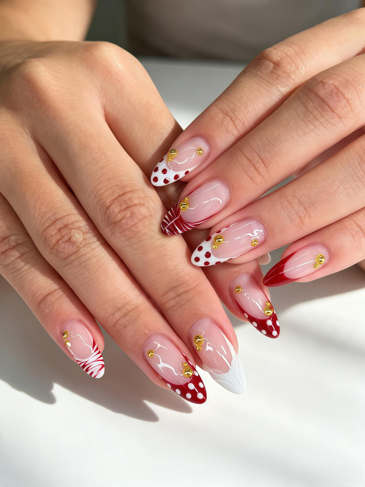 Red and White Polka Dot French Tip Nails with Gold-Toned Bead Details