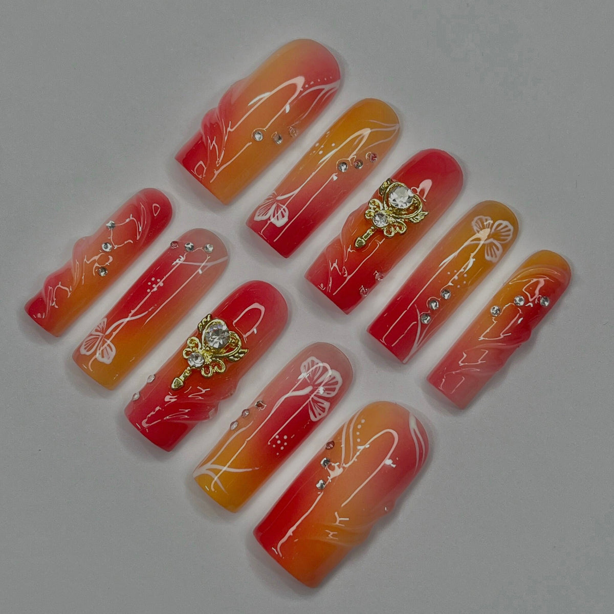 Red, Coral and Orange Gradient Nail Set with White Line Art and Crystal Charms