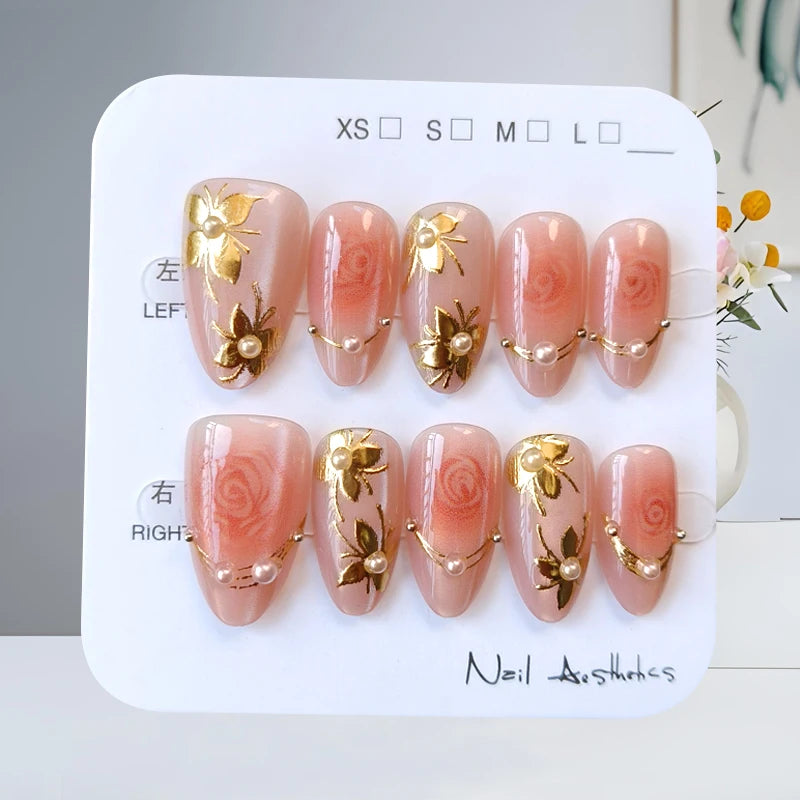 Sheer Dusty Pink Nails with Gold Floral Ornaments and Pearl Details
