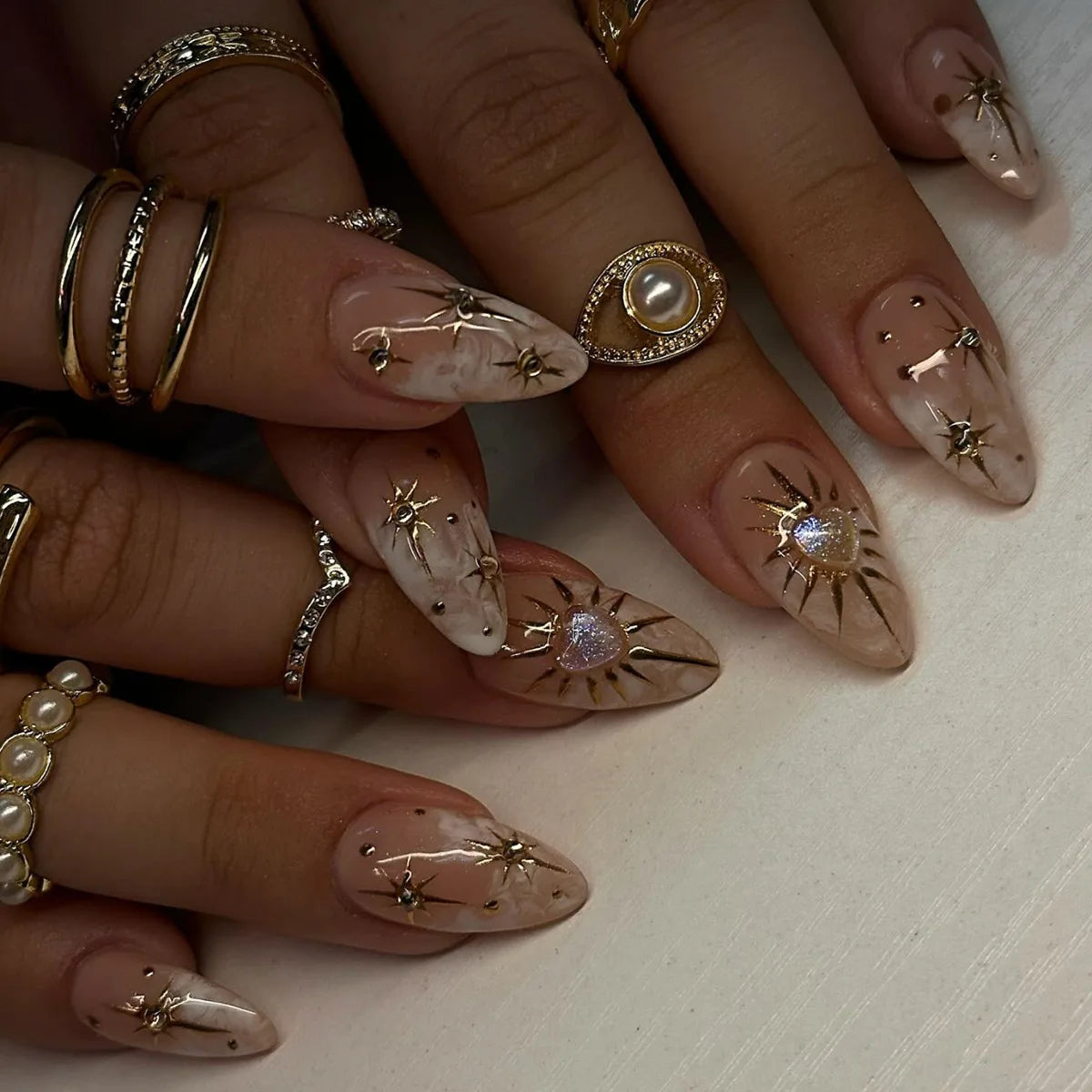 Sheer Nude Pink Celestial Nails With Gold Starbursts and Pearl Details