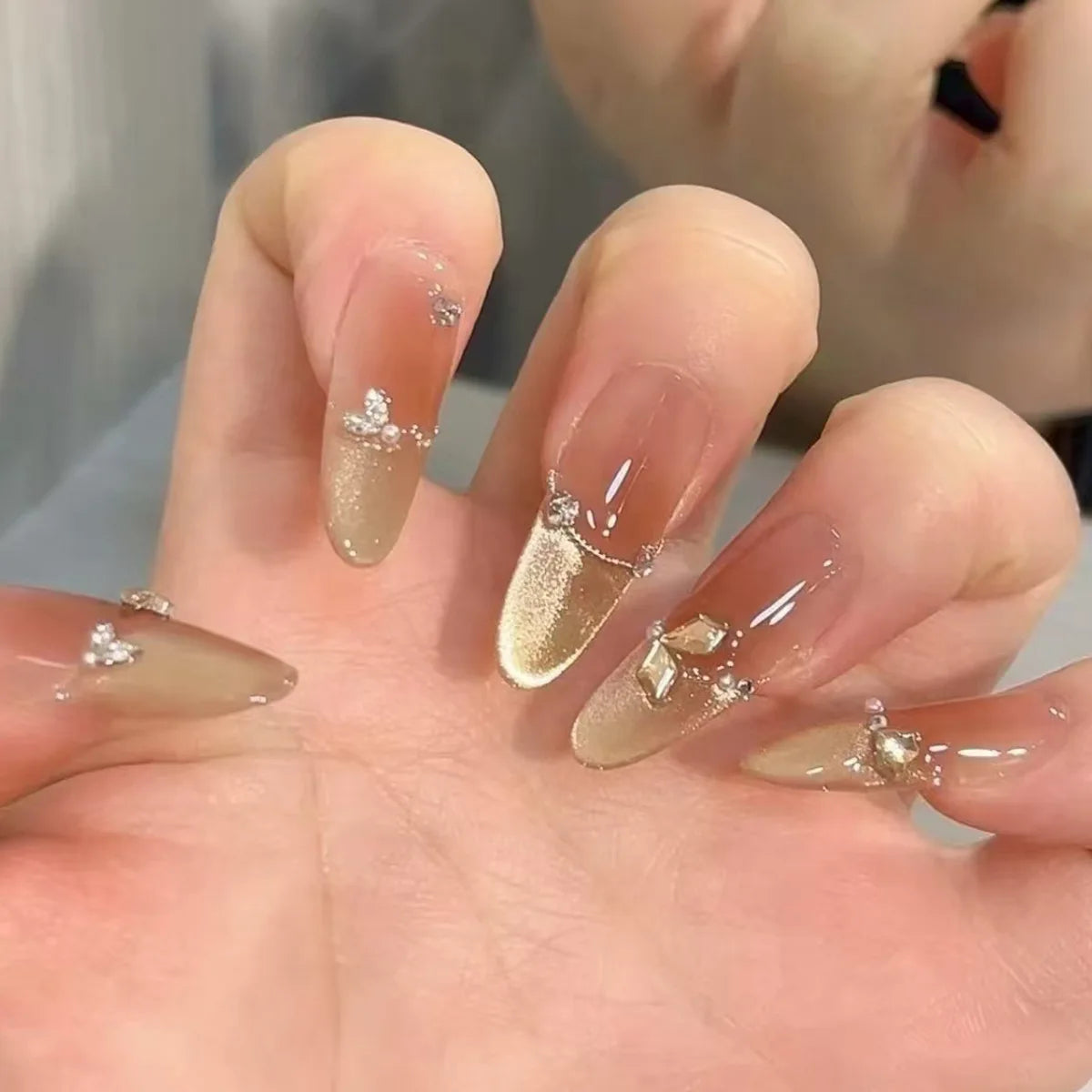 Sheer Nude Pink French Tip Nails with Gold Cat Eye Glitter and Rhinestones